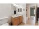 Bright bathroom featuring a wood vanity, and a combined tub and shower, for a functional design at 2256 Lake Pointe Cir, Leesburg, FL 34748