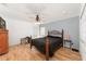 Bedroom with a metal bed frame, ceiling fan, laminate floors and plenty of natural light at 2256 Lake Pointe Cir, Leesburg, FL 34748