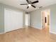 Bedroom with wood laminate flooring, closet, and ensuite access at 2256 Lake Pointe Cir, Leesburg, FL 34748