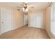 Bedroom featuring wood laminate flooring, a ceiling fan, and a large closet for storage at 2256 Lake Pointe Cir, Leesburg, FL 34748