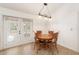 Cozy dining room with a round wooden table set near doors to the outdoor area at 2256 Lake Pointe Cir, Leesburg, FL 34748