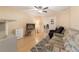 Comfortable living room featuring wood laminate flooring, neutral walls, and a ceiling fan at 2256 Lake Pointe Cir, Leesburg, FL 34748