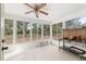 Bright sunroom with large windows offering views of the surrounding greenery at 2256 Lake Pointe Cir, Leesburg, FL 34748