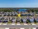 Neighborhood aerial view showcases the home's location near a scenic lake and lush greenery at 2365 Palm Park Loop, Clermont, FL 34714