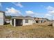 Backyard view of the house with a screened-in porch and spacious yard at 2365 Palm Park Loop, Clermont, FL 34714