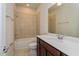 Bathroom featuring a tub with tile surround and a vanity with modern fixtures at 2365 Palm Park Loop, Clermont, FL 34714