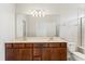 Bright bathroom featuring a double vanity with a large mirror and modern fixtures at 2365 Palm Park Loop, Clermont, FL 34714