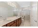 Bathroom featuring a double vanity, large mirror, and glass enclosed shower at 2365 Palm Park Loop, Clermont, FL 34714