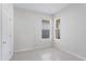 Bedroom featuring neutral walls and tile floor with two windows at 2365 Palm Park Loop, Clermont, FL 34714