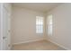 Bright bedroom featuring two windows, neutral-colored walls, and a closet for ample storage at 2365 Palm Park Loop, Clermont, FL 34714