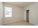 Cozy bedroom with tile flooring, closet, and a window with blinds, offering a comfortable space at 2365 Palm Park Loop, Clermont, FL 34714