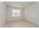 Bright bedroom with neutral paint, tile floors, and a window providing natural light at 2365 Palm Park Loop, Clermont, FL 34714