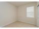 Simple bedroom featuring a window and closet, with tiled flooring and neutral walls at 2365 Palm Park Loop, Clermont, FL 34714