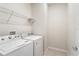 Bright laundry room equipped with modern washer and dryer at 2365 Palm Park Loop, Clermont, FL 34714