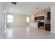 Open concept living room and kitchen area with tile flooring and natural light from multiple windows at 2365 Palm Park Loop, Clermont, FL 34714