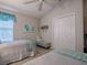 Comfortable bedroom with two twin beds, vaulted ceiling, closet, and a soothing color scheme at 2506 Greenhill Trl, The Villages, FL 32162