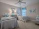 Charming bedroom showcasing two twin beds, soft decor, and ample natural light creating a tranquil space at 2506 Greenhill Trl, The Villages, FL 32162