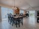 Open dining and living space with tile floors, slider to lanai, neutral walls and abundant natural light at 2506 Greenhill Trl, The Villages, FL 32162