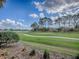 Scenic view of the lush green golf course with a smooth cart path on a clear sunny day at 2506 Greenhill Trl, The Villages, FL 32162