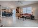 Bright and airy living room features a large window, tile floors, and seamless flow into dining area and kitchen at 2506 Greenhill Trl, The Villages, FL 32162