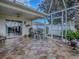 Covered and enclosed patio featuring neutral flooring, ceiling fan, seating, and sliding glass doors at 2506 Greenhill Trl, The Villages, FL 32162