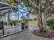 Screened in patio has tiled floors, potted plants, and views of the golf course at 2506 Greenhill Trl, The Villages, FL 32162