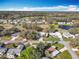 Aerial view of a neighborhood with mature trees, and a community pond at 25546 Belle Alliance, Leesburg, FL 34748