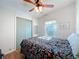 Cozy bedroom featuring ceiling fan, window, and closet at 25546 Belle Alliance, Leesburg, FL 34748