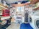 Organized garage with shelving, workbench, tools, and laundry area at 25546 Belle Alliance, Leesburg, FL 34748