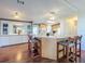 Kitchen with breakfast bar and white cabinetry with adjacent built-in mirrored cabinet and drawers at 25546 Belle Alliance, Leesburg, FL 34748