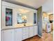 Built-in cabinets with a mirror and glass display cabinets separate the kitchen from the main living space at 25546 Belle Alliance, Leesburg, FL 34748