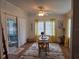 Sunny dining area with sliding door access and bright yellow decorative curtains at 263 Pinewood Dr, Eustis, FL 32726