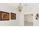 Dining room displaying chandelier, neutral paint, and artwork at 3176 Atwell Ave, The Villages, FL 32162