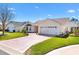 Well-maintained home featuring an attached two-car garage, a driveway, and a neatly manicured lawn at 3176 Atwell Ave, The Villages, FL 32162