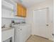 The laundry room features wooden cabinets and a utility sink at 3176 Atwell Ave, The Villages, FL 32162