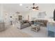 Bright living room featuring neutral walls, tile floors, couches, and ceiling fan at 3176 Atwell Ave, The Villages, FL 32162