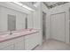 Bright bathroom with double sinks, large mirror, and a walk-in shower at 321 Ranchwood Dr, Leesburg, FL 34748