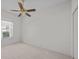 Bedroom features a ceiling fan and window overlooking the exterior view at 321 Ranchwood Dr, Leesburg, FL 34748