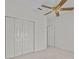 Bedroom features a closet with folding doors and a ceiling fan at 321 Ranchwood Dr, Leesburg, FL 34748