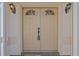 Front entry with double doors and decorative lighting fixtures at 321 Ranchwood Dr, Leesburg, FL 34748