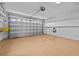 Spacious garage with storage racks and well-lit door at 321 Ranchwood Dr, Leesburg, FL 34748