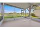 Screened-in porch with view of pond and grassy landscape at 321 Ranchwood Dr, Leesburg, FL 34748