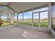 Relaxing screened porch offers tranquil views of the pond and lush landscaping in the background at 321 Ranchwood Dr, Leesburg, FL 34748