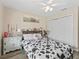 Comfortable bedroom with a cow themed bedding, ceiling fan, and artwork at 3318 Dzuro Dr, Oxford, FL 34484