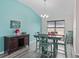 Dining area with stylish table set under a modern chandelier and attractive accent wall at 3318 Dzuro Dr, Oxford, FL 34484