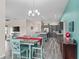 Open-concept dining area adjacent to kitchen, with modern gray cabinets, granite counters, and breakfast bar at 3318 Dzuro Dr, Oxford, FL 34484