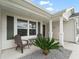 Inviting front porch with chairs, a table, and minimalist landscaping at 3318 Dzuro Dr, Oxford, FL 34484