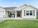 Inviting front porch with chairs, a table, and minimalist landscaping at 3318 Dzuro Dr, Oxford, FL 34484