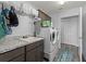 Laundry room showcasing a white washer and dryer, utility sink and white cabinets at 3318 Dzuro Dr, Oxford, FL 34484