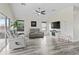 Bright living room with a ceiling fan, contemporary furniture, and sliding glass door for natural light at 3318 Dzuro Dr, Oxford, FL 34484